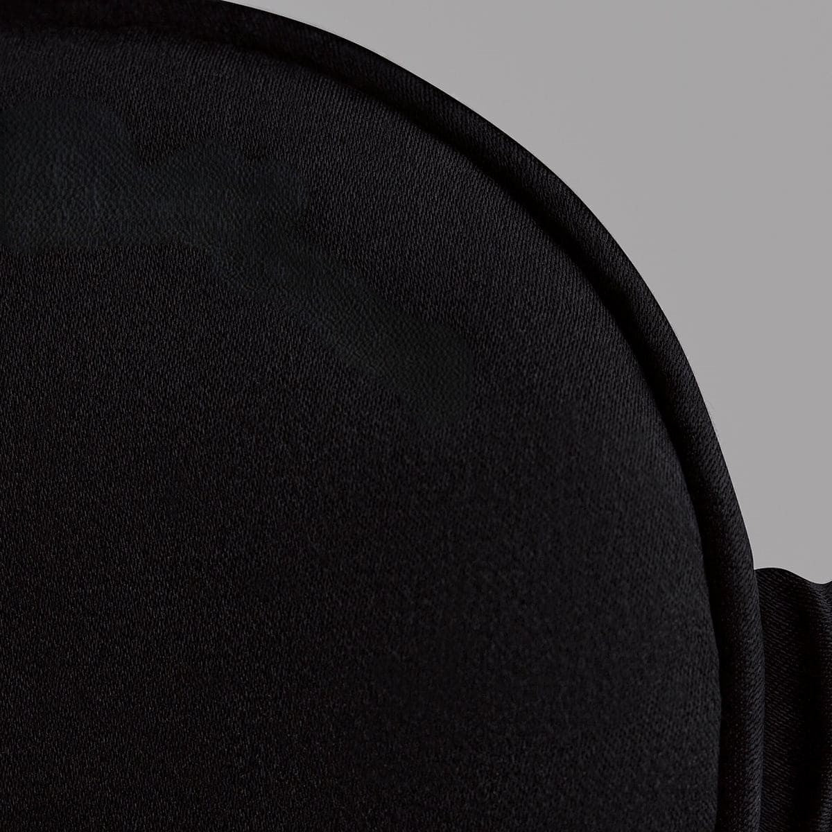 Close-up of a black fabric texture on a gray background