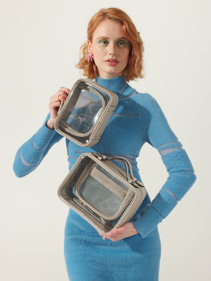 Model holding CALPAK clear makeup case in small and medium sizes in white; CMM2201-STONE