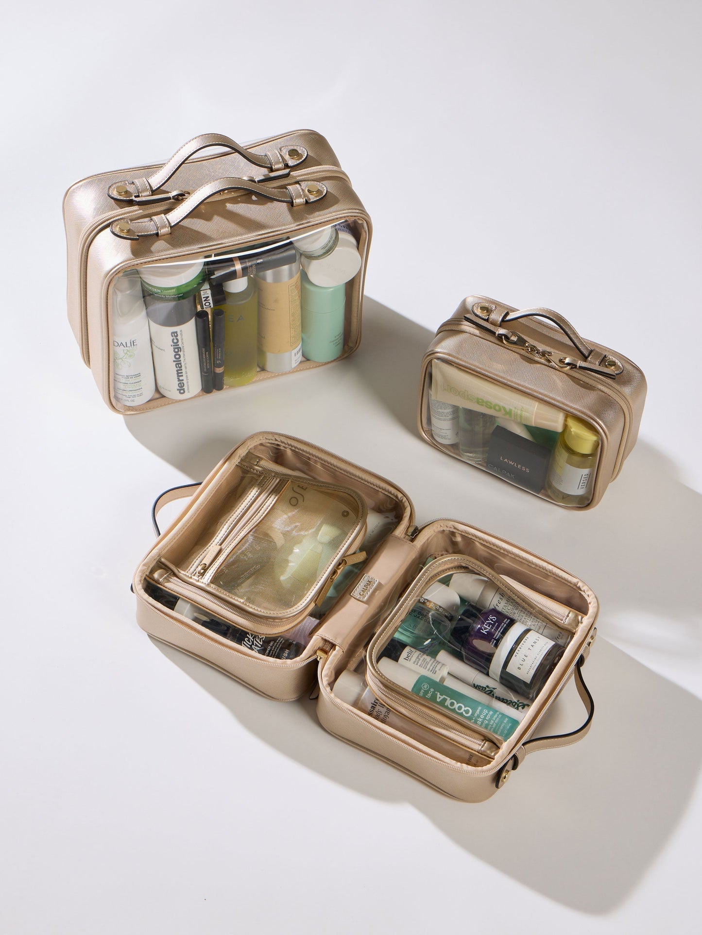 Gold CALPAK Small Clear Cosmetic Case, Medium Cosmetic Case, and Large Clear Cosmetic Case; CCM2001-GOLD